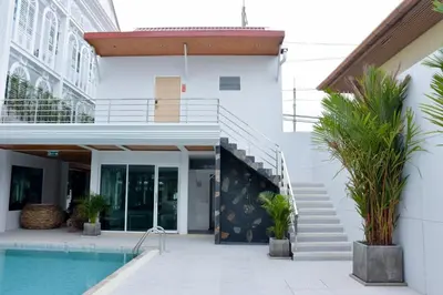 a house with a swimming pool and a staircase at Peranakan House in Phuket Town