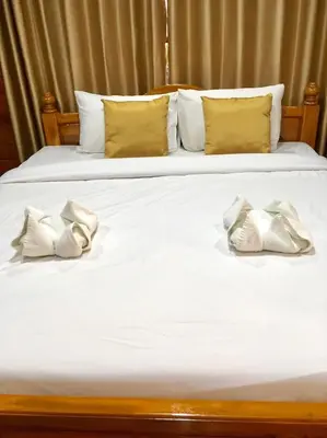 a bed with two white pillows on it at Life and Love house in Ban Na Noi
