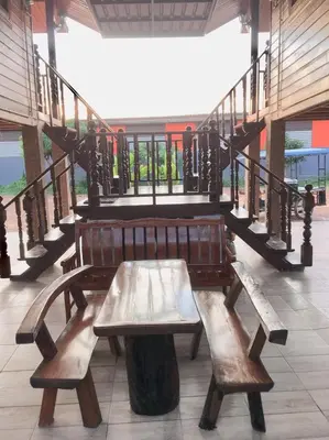 a wooden bench sitting in front of a staircase at Life and Love house in Ban Na Noi