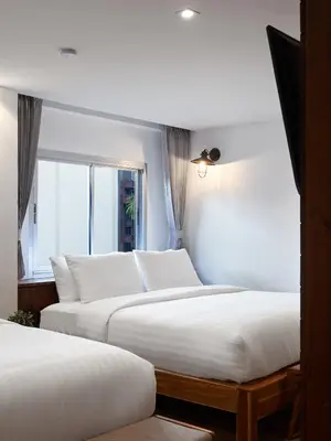 two beds in a room with a window at P2 Wood Loft in Phi Phi Don