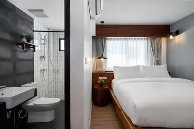 a bedroom with a bed and a bathroom with a sink at P2 Wood Loft in Phi Phi Don