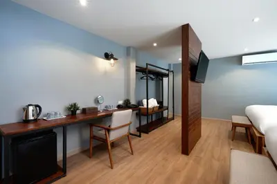 a room with a bed and a desk with a bed and a bed at P2 Wood Loft in Phi Phi Don