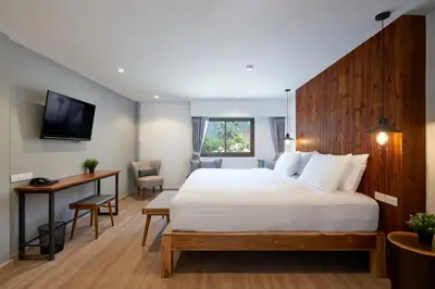 a bedroom with a large white bed and a desk at P2 Wood Loft in Phi Phi Don