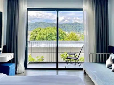 a hotel room with a view of a balcony at Seabed Grand Hotel Phuket in Phuket Town