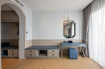 a dressing room with a blue desk and a mirror at Seabed Grand Hotel Phuket in Phuket Town