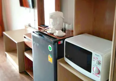 a microwave sitting on a counter in a kitchen at Studio Sea View Patong in Patong Beach