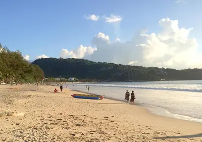 a group of people walking on a beach at Studio Sea View Patong in Patong Beach
