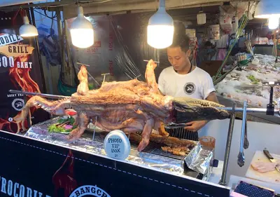 a man standing behind a stand with a large turkey at Studio Sea View Patong in Patong Beach
