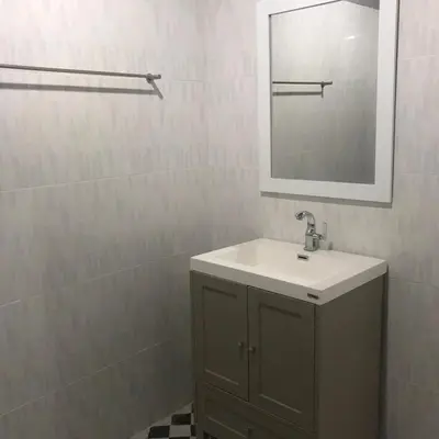 a bathroom with a sink and a mirror at Aladdin Guest House in Phi Phi Don