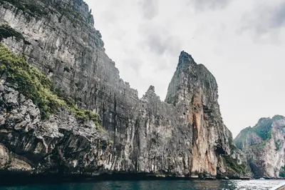 a view of a mountain from a boat in the water at Aladdin Guest House in Phi Phi Don
