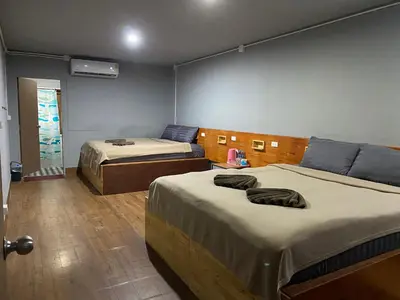 a room with two beds in a room at Aladdin Guest House in Phi Phi Don