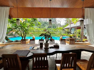 a dining room with a table and chairs and a pool at Saifon Villas - Luxurious Pool Villas in Ao Nang Beach