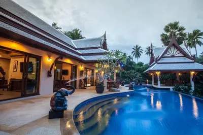 a swimming pool in front of a house at Saifon Villas - Luxurious Pool Villas in Ao Nang Beach