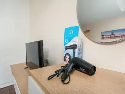 a hair dryer sitting on a desk next to a tv at Naithon Beachfront Condotel in Nai Thon Beach