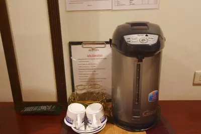 a coffee maker sitting on top of a table at Baan Veerakit Hotel in Patong Beach