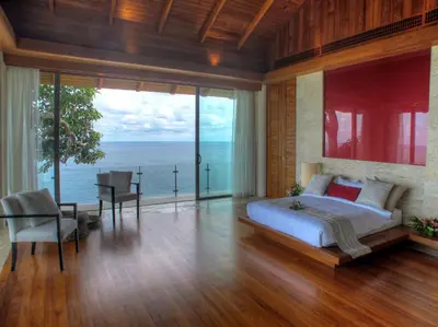 a bedroom with a bed and a view of the ocean at Villa Minh in Kamala Beach