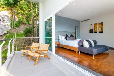 a master bedroom with a bed and a balcony at Villa Beyond 9 Bedrooms Seaview - Full Services in Bang Tao Beach