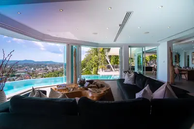 a living room with a couch and a large window at Villa Beyond 9 Bedrooms Seaview - Full Services in Bang Tao Beach