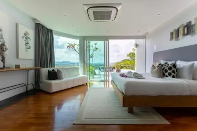 a bedroom with two beds and a large window at Villa Namaste 7 Bedroom Fully Staffed Seaview Villa in Bang Tao Beach