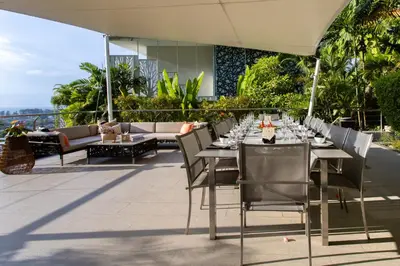 a restaurant with tables and chairs on a patio at Villa Namaste 7 Bedroom Fully Staffed Seaview Villa in Bang Tao Beach
