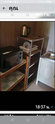 a picture of a kitchen with a stove and a microwave at Teahouse in Phuket Town