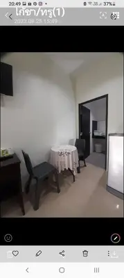 a room with a table and a chair and a television at Teahouse in Phuket Town
