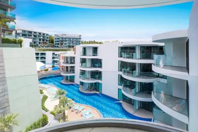 an aerial view of a building with a swimming pool at Lets Phuket Twin Sands Resort & Spa in Patong Beach