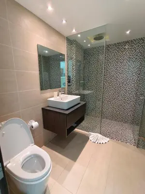 a bathroom with a toilet and a sink and a shower at Lets Phuket Twin Sands Resort & Spa in Patong Beach