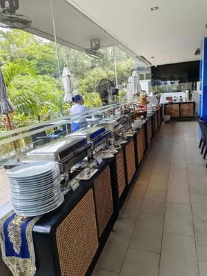 a kitchen with a counter with plates on it at Lets Phuket Twin Sands Resort & Spa in Patong Beach