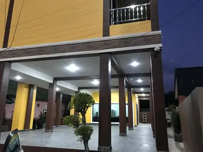 a view of a building with columns and lights at G-HAN Residence in Nai Yang Beach
