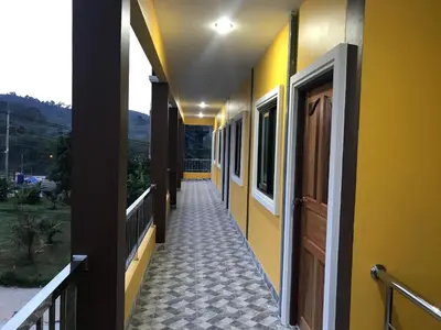 a corridor of a building with yellow walls at G-HAN Residence in Nai Yang Beach
