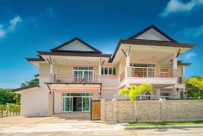 a large house with a fence in front of it at Phuket9 Residence in Chalong