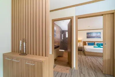 a room with a bedroom with a bed and a mirror at Phuket9 Residence in Chalong
