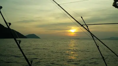 a view of the ocean from a boat at sunset at Austrian Garden Hotel & Restaurant Patong in Patong Beach
