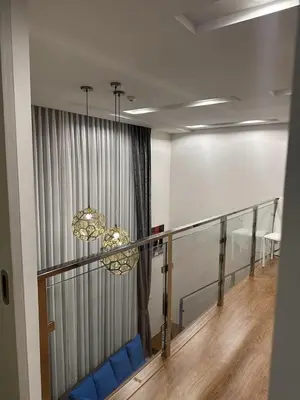 a room with a balcony with blue chairs and a chandelier at Unique loft 2-BR near of Surin Beach, private patio in Surin Beach