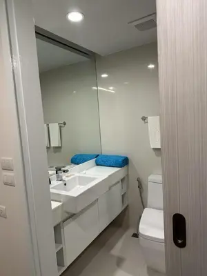 a bathroom with a sink and a toilet and a mirror at Unique loft 2-BR near of Surin Beach, private patio in Surin Beach