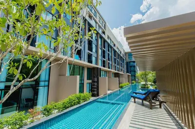 a swimming pool in the middle of a building at Unique loft 2-BR near of Surin Beach, private patio in Surin Beach