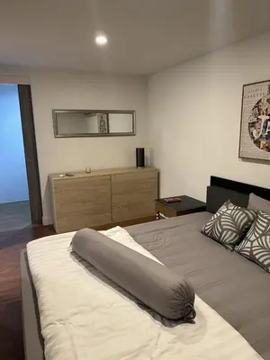 a bedroom with a bed with a pillow on it at Unique loft 2-BR near of Surin Beach, private patio in Surin Beach