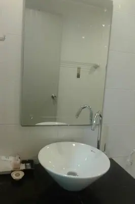 a white sink in a bathroom with a mirror at Phupara Place SHA Certified in Phuket Town