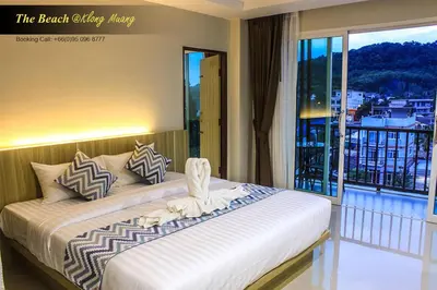 a bedroom with a large bed with a balcony at The Beach at Klong Muang in Klong Muang Beach