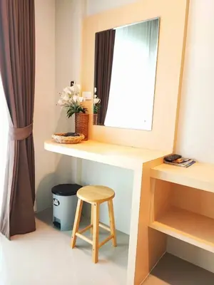 a dressing table with a mirror and a stool at The Beach at Klong Muang in Klong Muang Beach