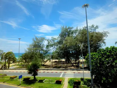 an empty street with trees and a street light at Fishtail Hostel Phuket in Karon Beach