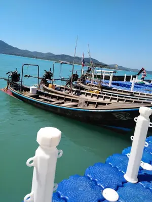 a boat is docked in the water next to at Antonio's Ko Yao Noi in Ko Yao Noi