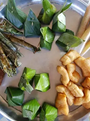 a plate of food with green vegetables and chopsticks at Antonio's Ko Yao Noi in Ko Yao Noi