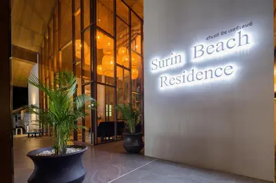 a entrance to a sunbeam beach restaurant with potted plants at Palmyrah Surin Beach Residence in Surin Beach