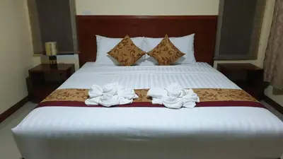 a bedroom with a bed with two towels on it at ฺBankunyaiy Resort in Ko Yao Yai