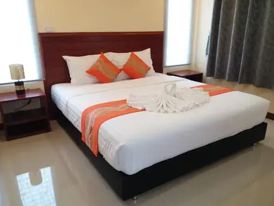 a bedroom with a large bed with white sheets at ฺBankunyaiy Resort in Ko Yao Yai