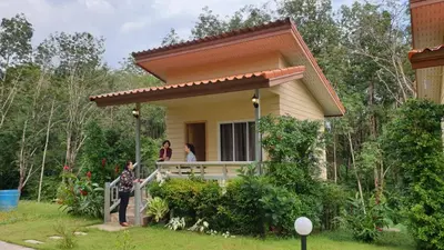a small house with people standing on the porch at ฺBankunyaiy Resort in Ko Yao Yai