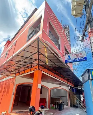 a red building with a balcony on top of it at Praew Mansion in Kamala Beach