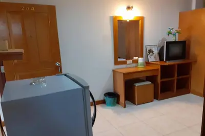 a living room with a television and a mirror at Praew Mansion in Kamala Beach